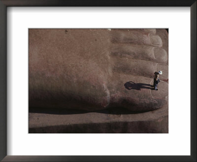 A Person Stands On The Big Toe Of The Sitting Buddha Statue At Leshan by Jodi Cobb Pricing Limited Edition Print image