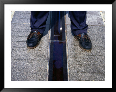 Feet Standing On The East/West Meridian Line At The Royal Observatory, Greenwich, London, Uk by Charlotte Hindle Pricing Limited Edition Print image