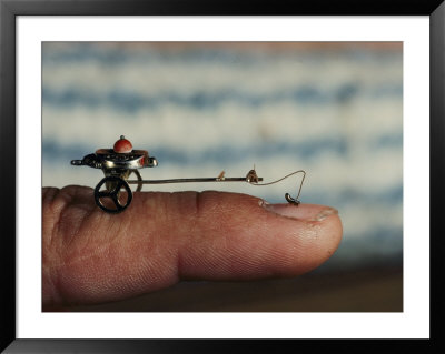 A Flea Pulls A Small Cart Along An Outstretched Finger by Nicole Duplaix Pricing Limited Edition Print image