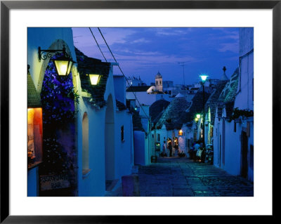 Typical Cobbled Lane In Trulli District At Dusk, Alberobello, Puglia, Italy by David Tomlinson Pricing Limited Edition Print image