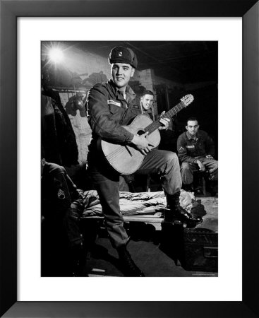Elvis Presley Sporting Army Cap And Battle Fatigues As He Plays Guitar During 7 Weeks Of Training by Loomis Dean Pricing Limited Edition Print image