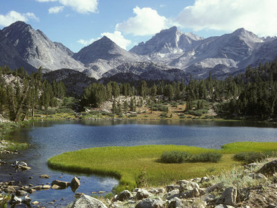 Sierra Mountain Lake In Summer With Grassy Shores And Peaks by Stephen Sharnoff Pricing Limited Edition Print image