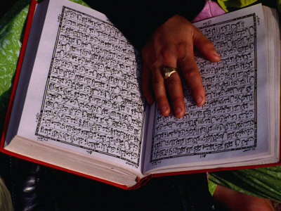 Hand Resting On Open Koran (Qaran), Delhi, India by Richard I'anson Pricing Limited Edition Print image