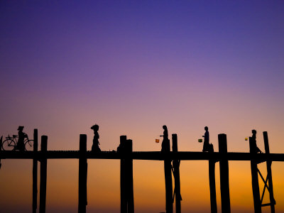 People Crossing The Ubein Bridge In Mandalay, Myanmar At Sunset by Scott Stulberg Pricing Limited Edition Print image