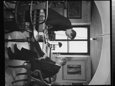 Actor Frank Craven With George Freedley In His Office, In Top Stack Of The New York Public Library by Alfred Eisenstaedt Pricing Limited Edition Print image