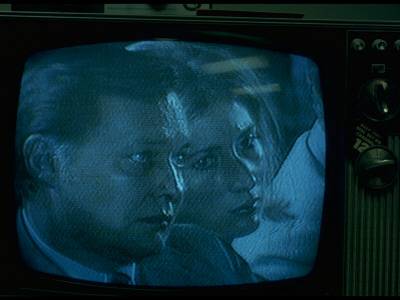 Tv Image Of Two Unidentified Staff Members Listening To President Nixon's Farewell Speech by Gjon Mili Pricing Limited Edition Print image