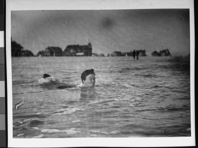 A Woman Making A Face As She Dogs Paddles In The Water At The Beach by Wallace G. Levison Pricing Limited Edition Print image