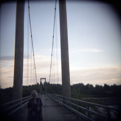 Senior Woman Walking On A Bridge, Boden, Norrbotten, Sweden by Inger Bladh Pricing Limited Edition Print image