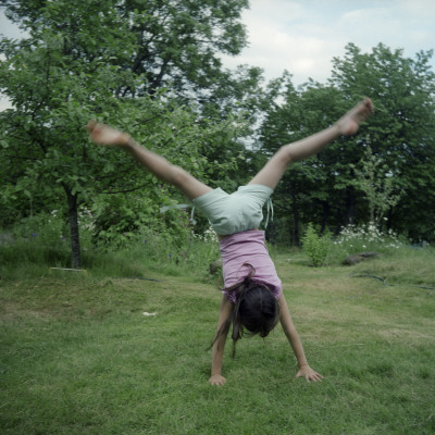 Rear View Of A Girl Doing A Cartwheel In A Park by Mikael Andersson Pricing Limited Edition Print image