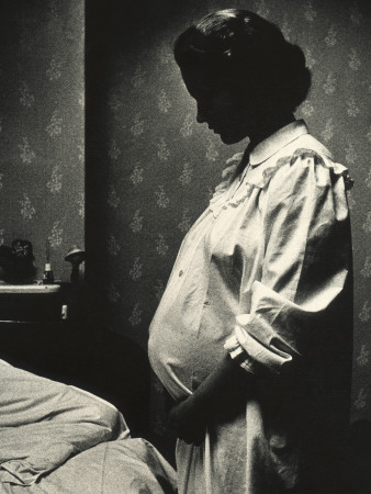 Side Profile Of A Pregnant Woman Standing In A Bed Room by Hans Hammarskjold Pricing Limited Edition Print image
