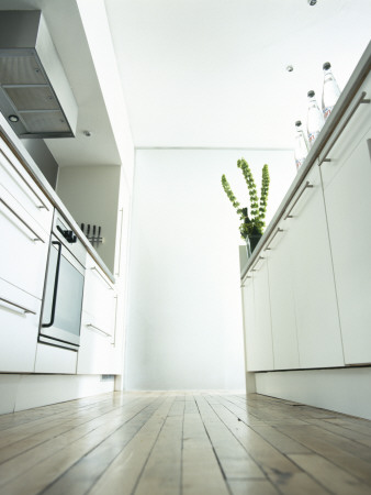 Cool White Modern Urban Kitchen At Floor Level In Loft Apartment by Richard Powers Pricing Limited Edition Print image