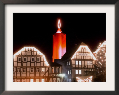 A Huge Christmas Candle Appears Above The Roofs In The Old City Of Schlitz, Germany by Heribert Proepper Pricing Limited Edition Print image