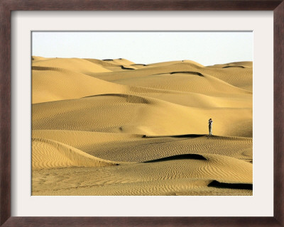 A Visitor Stands On Sand Dune In The Taklimakan Desert by Eugene Hoshiko Pricing Limited Edition Print image
