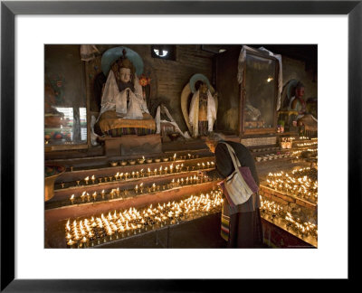 Old Woman Lighting Butter Lamps In Front Of Buddha Statues Draped With New Silk Scarves by Don Smith Pricing Limited Edition Print image