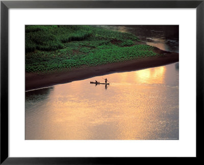 Sunset On Karo Men In A Dugout Raft, Omo River, Ethiopia by Janis Miglavs Pricing Limited Edition Print image