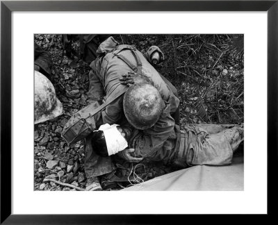 American Soldier Comforting Wounded Comrade During Fight To Take Saiapn From Japanese Troops by W. Eugene Smith Pricing Limited Edition Print image