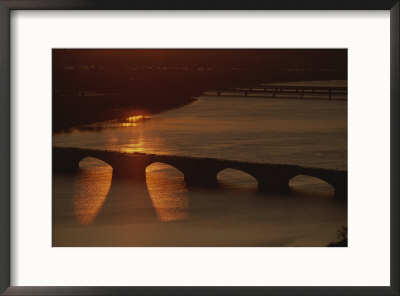 Sunlight Reflects Off The Potomac, Silhouetting Memorial Bridge by Sisse Brimberg Pricing Limited Edition Print image