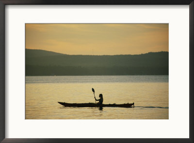 A Woman Paddles Her Kayak On The Calm Water At Twilight by Skip Brown Pricing Limited Edition Print image
