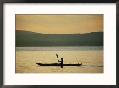 A Woman Paddles Her Kayak On The Calm Water At Twilight by Skip Brown Pricing Limited Edition Print image