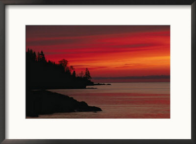 A Bright Red Sky Over Lake Superior At Dawn With Silhouettes Of The Rocky Coast by Maria Stenzel Pricing Limited Edition Print image