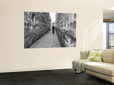 Man Standing In Narrow Alleyway, Tongli, Jiangsu, China (Black And White) by Ian Trower Pricing Limited Edition Print image