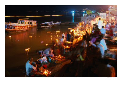Candles Streak Waters Of The Ganges During Dawali Festival, Varanasi, Uttar Pradesh, India by Greg Elms Pricing Limited Edition Print image
