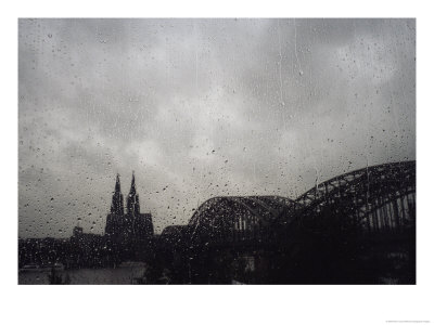 A View Of A Bridge And Spired Building From A Rain-Spattered Window by Raul Touzon Pricing Limited Edition Print image