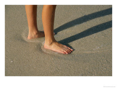 Feet In The Wet Sand Of A Beach Wait For The Next Surge Of Surf by Paul Damien Pricing Limited Edition Print image