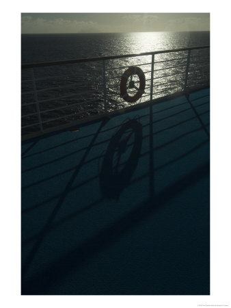 Life Preserver Hanging On A Railing Of A Cruise Ship Deck At Sunset by Todd Gipstein Pricing Limited Edition Print image