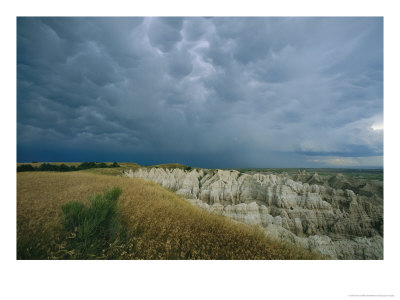 Storm Clouds Gather Over The Southern Unit Of South Dakotas Badlands by Annie Griffiths Belt Pricing Limited Edition Print image