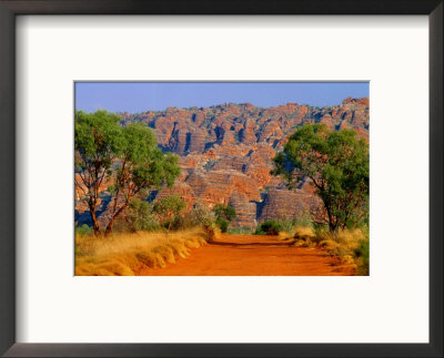 Natural Rock Formations Of Bungle Bungles And Dirt Road Leading To It, Purnululu Np, Australia by John Banagan Pricing Limited Edition Print image