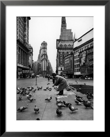 Man Feeding Pigeons In An Empty Times Square During A Taxi Strike by Yale Joel Pricing Limited Edition Print image