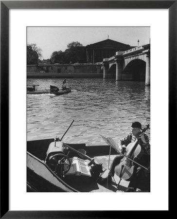 Man Playing Cello On Boat by Loomis Dean Pricing Limited Edition Print image