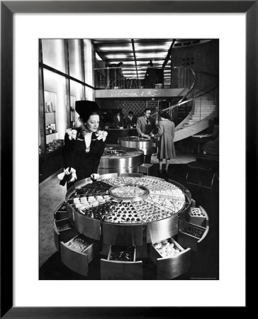 Shopper Looking At Selection Of Chocolates In Elegant Fifth Avenue Candy Store by Alfred Eisenstaedt Pricing Limited Edition Print image