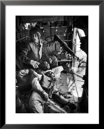 Helicopter Crew Chief James C. Farley Shouting To Crew As Wounded Comrades Lay Dying At His Feet by Larry Burrows Pricing Limited Edition Print image