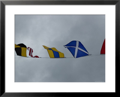Close View Of Nautical Flags Waving Against A Cloudy Sky, Mystic, Connecticut by Todd Gipstein Pricing Limited Edition Print image