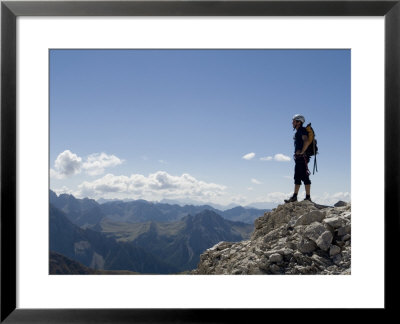 Rock Climber Stands On A Mountain Summit In The Dolomites, Italy by Bill Hatcher Pricing Limited Edition Print image