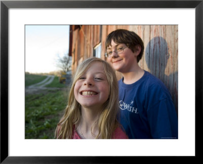 Two Siblings Play Near An Old Barn In Nebraska by Joel Sartore Pricing Limited Edition Print image