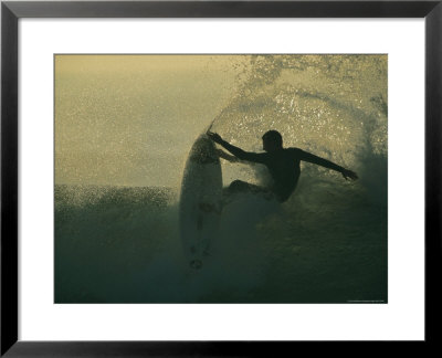 In A Spray Of Surf, A Surfer Leaps Up On A Breaking Wave by Tim Laman Pricing Limited Edition Print image