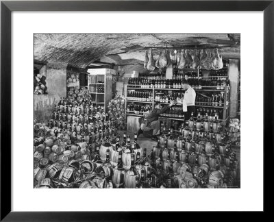 Cellarman At Giannino's Handing Bottle Of Wine To Waiter For His Customers by Alfred Eisenstaedt Pricing Limited Edition Print image