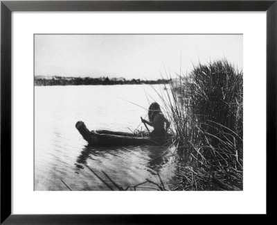 Pomo Indian Poling His Boat Made Of Tule Rushes Through Shallows Of Clear Lake, Northen California by Edward S. Curtis Pricing Limited Edition Print image