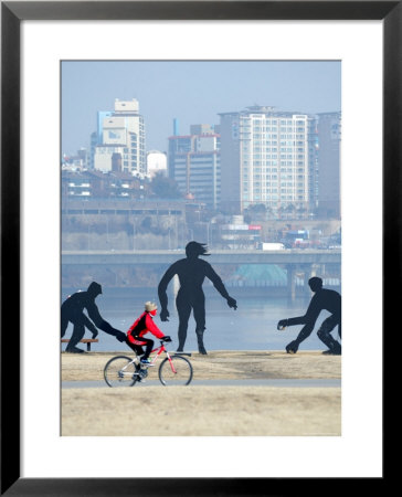 Person Cycling Past Sculptures On Han River Cycleway, Sinchon And Yeouido, Seoul, South Korea by Anthony Plummer Pricing Limited Edition Print image