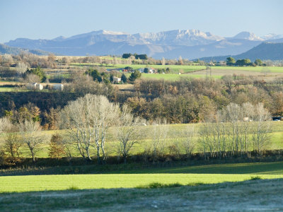 January Long View Of Green Fields, Houses And Hills In Provence, France by Stephen Sharnoff Pricing Limited Edition Print image