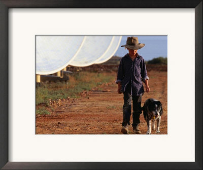 Boy With Dog Walking Past Solar Energy Dishes, New South Wales, Australia by Oliver Strewe Pricing Limited Edition Print image