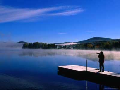 Photographer On Pier Of Lake Superior Near Mount Tremblant, Quebec, Canada by Alain Evrard Pricing Limited Edition Print image