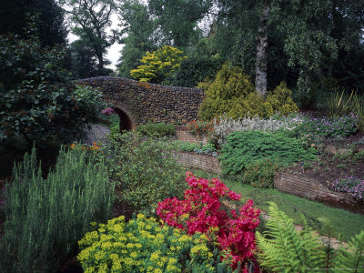 Walkway Under Stone Bridge Along Mixed Planting In Raised Beds, Norfolk Mother's Day by Robert Estall Pricing Limited Edition Print image