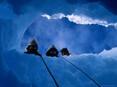 Three Explorers Looking Through Hole In Ice, Antarctica by Chester Jonathan Pricing Limited Edition Print image