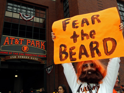 Texas Rangers V San Francisco Giants, Game 1: A Fan Of The San Francisco Giants Hold Signs by Petersen Christian Pricing Limited Edition Print image