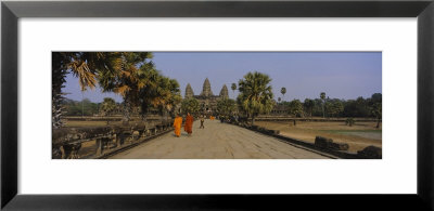 Two Monks Walking In Front Of An Old Temple, Angkor Wat, Siem Reap, Cambodia by Panoramic Images Pricing Limited Edition Print image