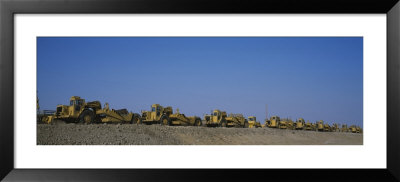 Row Of Bulldozers At A Construction Site by Panoramic Images Pricing Limited Edition Print image